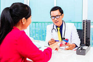 bigstock-Asian-doctor-giving-patient-me-61689992