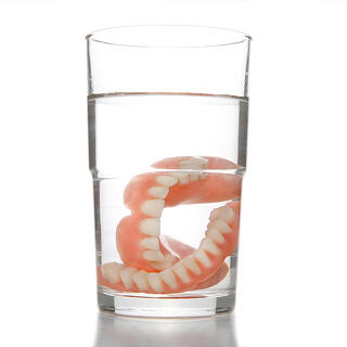 bigstock-Denture-In-Glass-4951648
