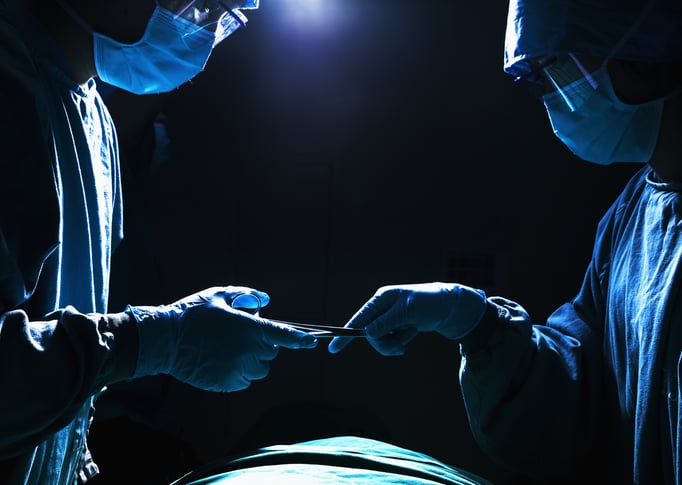 bigstock-Two-surgeons-working-and-passi-52318804